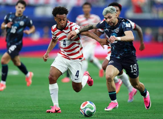 (260613) -- LOS ANGELES, June 13, 2026 -- Tyler Adams (L) of the United States vies with Julio Enciso of Paraguay during the group D match between the United States and Paraguay at the 2026 FIFA World Cup, WM, Weltmeisterschaft, Fussball at Los Angeles Stadium in Los Angeles, the United States, June 12, 2026. ) (SP)U.S.-LOS ANGELES-FOOTBALL-FIFA WORLD CUP-GROUP D-USA VS PRY BaixXuefei 
