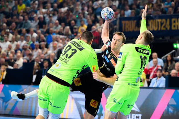 Cologne, Germany Handball EHF CL Final 4 Semifinal SC Magdeburg Fuechse Berlin from left in duel Mijajlo Marsenic Berlin and Felix Claar Magdeburg , Mathias Gidsel Berlin Cologne Lanxess Arena Nordrhein Westfalen Germany