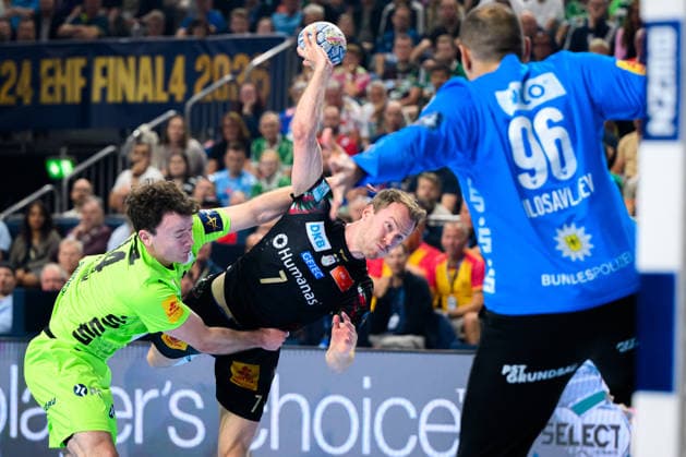 Cologne, Germany Handball EHF CL Final 4 Semi-Final SC Magdeburg Fuechse Berlin from left in duel Hakun West av Teigum Berlin , Felix Claar Magdeburg , Goalkeeper Dejan Milosavljev Berlin Cologne Lanxess Arena Nordrhein Westfalen Germany