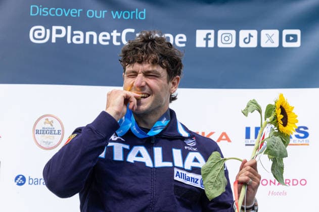 Raffaelo IVALDI ITA, Italy, winner Single Canoe, C1 , bites on his gold medal, award ceremony ICF Canoe Slalom World Cup 2026 Eiskanal Augsburg