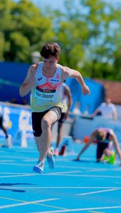 Sam Van Dooren Belgium, 132 runs with full body extension over the blue tartan track of the Michael Hoffmann Stadium in Mannheim In the background, another athlete prepares in the starting blocks Sam Van Dooren 132 sprinting in the Michael Hoffmann Stadium Mannheim Copyright: xspeedshotx