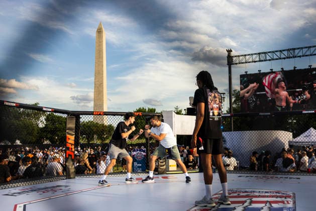 Fans of ultimate fighting pose for a photo on the Ellipse outside of the White House ahead of the UFC Freedom 250 ceremonial weigh-ins in Washington DC on Saturday, June 13, 2026. The martial arts bouts are scheduled to take place on the South Lawn of the White House on June 14.  WAX20260613929 JIMxLOxSCALZO