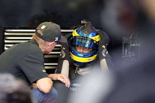 Father Patrick Bourdais FRA consoles Sebastian Bourdais FRA Cadillac V Series R 12 sitting on the ground with helmet on disappointed after a stop in the pits due to a technical defect, 24 Hours of Le Mans, France, WEC World Endurance Championship, 14 06 2026, problem with the leading race car until then