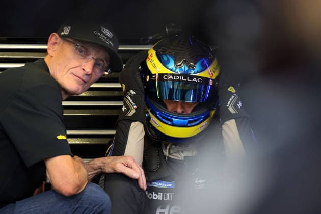 Father Patrick Bourdais FRA consoles the disappointed Sebastian Bourdias FRA Cadillac V Series R 12 sitting on the ground, with helmet on after a stop due to a technical defect in the pits, 24 Hours of Le Mans, France, WEC World Endurance Championship, 14 06 2026, problem with the leading race car until then
