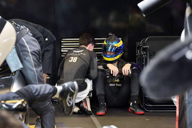 Jack Aitken GBR crouches next to Sebastian Bourdias FRA Cadillac V Series R 12 sitting disappointed with helmet on the ground after a stop due to a technical defect pit, 24 Hours of Le Mans, France, WEC World Endurance Championship, 14 06 2026, problem with the leading race car until then,