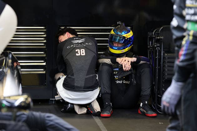 Jack Aitken GBR crouches, Sebastian Bourdias FRA Cadillac V Series R 12 sits with helmet on disappointed on the ground after a stop due to a technical defect in the pits, 24 Hours of Le Mans, France, WEC World Endurance Championship, 14 06 2026, problem with the previously leading race car