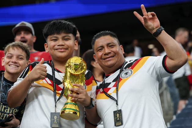 HOUSTON, TX - JUNE 14: Father and son Germany fans in the stands holding a replica World Cup trophy ahead of the FIFA World Cup, WM, Weltmeisterschaft, Fussball 2026 Group E match between Germany and Curacao on June 14, 2026, at Houston Stadium in Houston, Texas. (Photo by David Buono Icon Sportswire) SOCCER: JUN 14 FIFA World Cup 26 Group E - Germany vs Curacao EDITORIAL USE ONLY Icon260614002