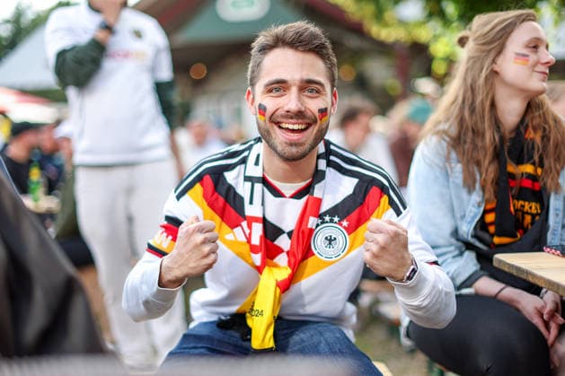 14 06 2026, Cologne, Public Viewing for the FIFA World Cup 2026, International match World Cup Germany Curacao, Fans A fan in the beer garden is looking forward to the game and cheering for the goal of the German national teams victory Feverish excitement North Rhine-Westphalia Germany