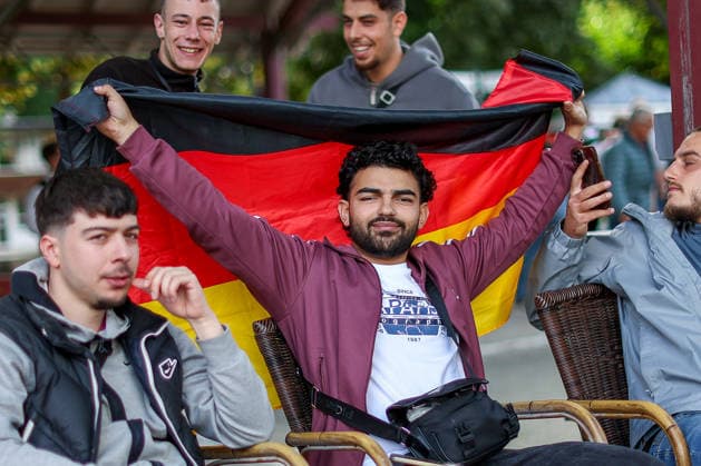 14 06 2026, Cologne, Public Viewing for the FIFA World Cup 2026, international match World Cup Germany Curacao, fans with German flag in the beer garden look forward to the game and cheer about the goal the victory of the German national team North Rhine-Westphalia Germany