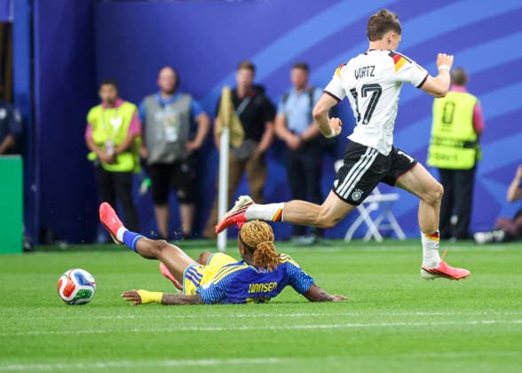 HOUSTON, TX - JUNE 14: Sontje Hansen 12 of Curacao slide tackless Florian Wirtz 17 of Germany fin the irst half during the FIFA World Cup, WM, Weltmeisterschaft, Fussball 2026 Group E match between Germany and Curacao on June 14, 2026 at Houston Stadium in Houston, Texas. (Photo by Leslie Plaza Johnson Icon Sportswire) SOCCER: JUN 14 FIFA World Cup 26 Group E - Germany vs Curacao EDITORIAL USE ONLY Icon260614004