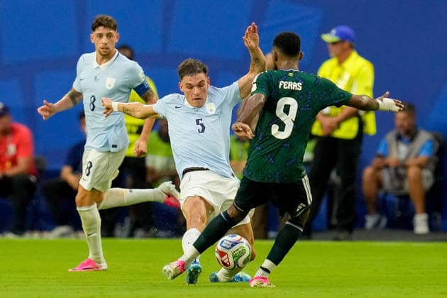 Manuel Ugarte of Uruguay and Feras Albrikan of Saudi Arabia battle for the ball during the 2026 FIFA World Cup Group H match between Saudi Arabia and Uruguay at Miami Stadium on June 15, 2026, in Miami, United States. Photo by Alex Gottschalk, DeFodi Images,detected_source_language