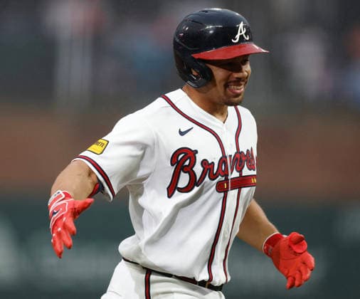 Catcher Drake Baldwin 30 of the Atlanta Braves shakes hands with third base coach Tommy Watkins 84 (not pictured) after hitting a solo home run in the first inning against the San Francisco Giants at Truist Park on Tuesday, June 16, 2026 in Atlanta, Georgia.  ATL20260616105 MikexZarrilli