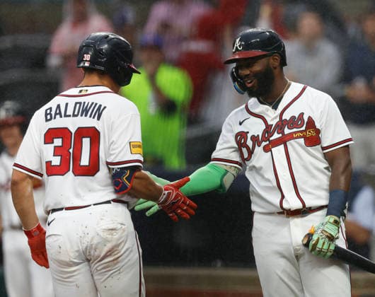 Catcher Drake Baldwin 30 of the Atlanta Braves shakes hands with centerfielder Michael Harris II (right) after Baldwin hit a solo home run in the first inning against the San Francisco Giants at Truist Park on Tuesday, June 16, 2026 in Atlanta, Georgia.  ATL20260616106 MikexZarrilli