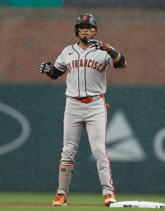 Second baseman Luis Arraez 1 of the San Francisco Giants gestures towards the dugout after hitting a double in the first inning against the Atlanta Braves at Truist Park on Tuesday, June 16, 2026 in Atlanta, Georgia.  ATL20260616108 MikexZarrilli