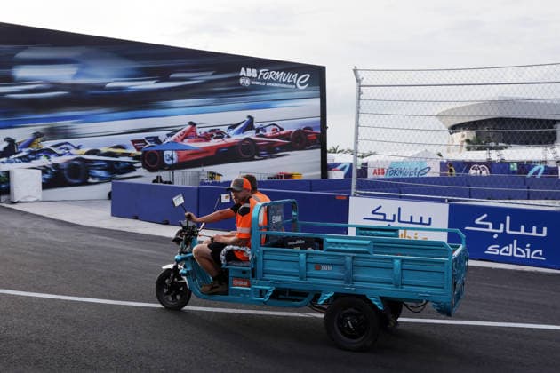 Staff members ride a motorized tricycle along the track, Hainan Island, China, FIA Formula E World Championship Season 12, Sanya E-Prix, China, June 17, 2026, preparations ,detected_source_language