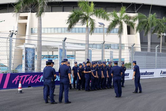 Members of the Chinese security forces stand on the racetrack at the start of Attack Mode, Hainan Island, China, FIA Formula E World Championship Season 12, Sanya E-Prix, China, June 17, 2026, preparations ,detected_source_language