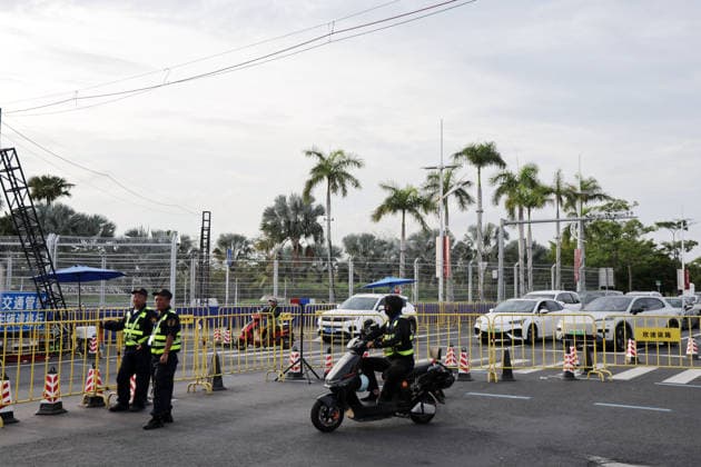 Security personnel at a roadblock at the intersection of Fengtang Road and Haitang North Road, Hainan Island, China, FIA Formula E World Championship Season 12, Sanya E-Prix, China, June 18, 2026, part of the race track,detected_source_language