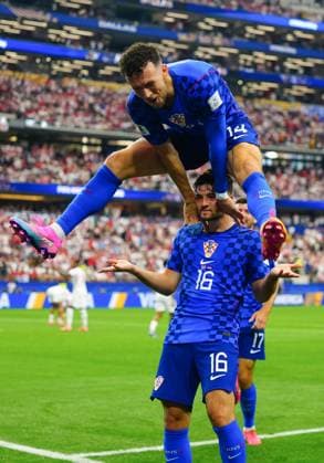 Martin Baturina celebrates scoring for Croatia with Ivan Perisic leaping over his shoulders England v Croatia, 2026 FIFA World Cup, WM, Weltmeisterschaft, Fussball Group L, Football, Dallas Stadium, Arlington, Texas, USA - 17 Jun 2026Arlington Dallas Stadium Texas (TX) United States of America EDITORIAL USE ONLY No use with unauthorised audio, video, data, fixture lists, club league logos or live services. Online in-match use limited to 120 images, no video emulation. No use in betting, games or single club league player publications.  Copyright: xJavierxGarcia Shutterstockx 16928920bo