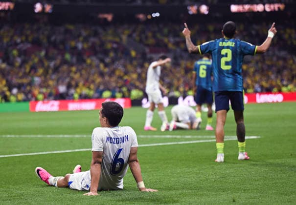 (260618) -- MEXICO CITY, June 18, 2026 -- Akmal Mozgovoy (L) of Uzbekistan sits on the court as Daniel Munoz of Colombia celebrates scoring during the group K match between Uzbekistan and Colombia at the FIFA World Cup, WM, Weltmeisterschaft, Fussball 2026 in Mexico City, Mexico, June 17, 2026. ) (SP)MEXICO-MEXICO CITY-FOOTBALL-FIFA WORLD CUP-GROUP K-UZB VS COL WuxWei 