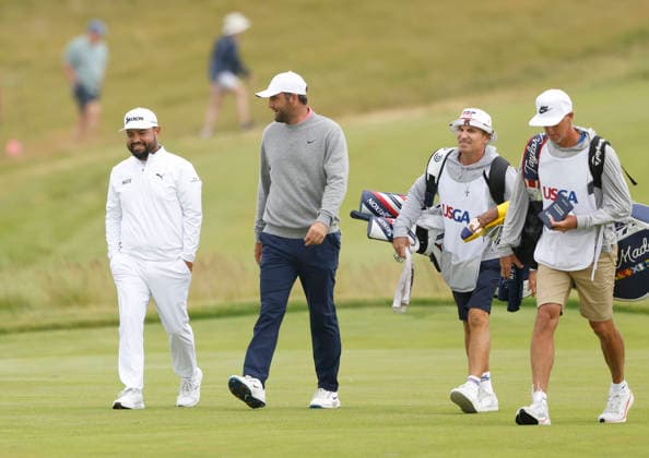 Scottie Scheffler and J.J. Spaun walk down the 1st fairway with their caddies during the first round of the 126th U.S. Open Golf Championship at Shinnecock Hills Golf Club in Southampton, NY, on Thursday, June 18, 2026.  NYC20260618819 JOHNxANGELILLO