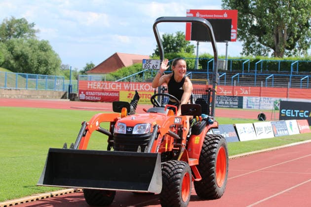 June 18, 2026 Track and Field 28th International Track and Field Meet ANHALT 2026 Training at Paul Greifzu Stadium in Dessau Gina Lückenkemper takes advantage of the time before her training session to take the greenkeepers’ tractor at Dessau’s Paul Greifzu Stadium for a short test drive Stadium, Dessau-Roßlau, Saxony-Anhalt, Germany,detected_source_language