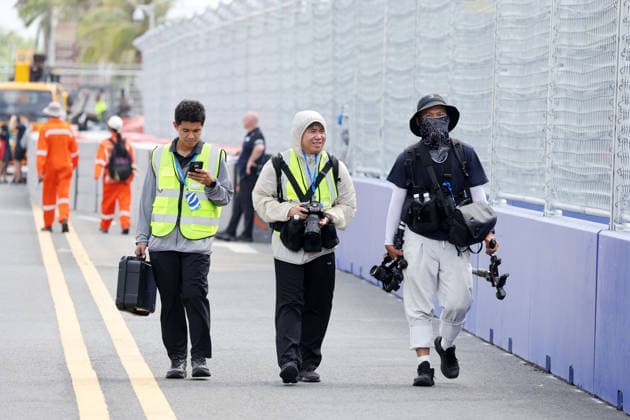 Three Chinese videographers wearing sunscreen while inspecting the track, Sanya E-Prix, China, June 19, 2026, Hainan Island, China, FIA Formula E World Championship Season 12, preparations, ,detected_source_language