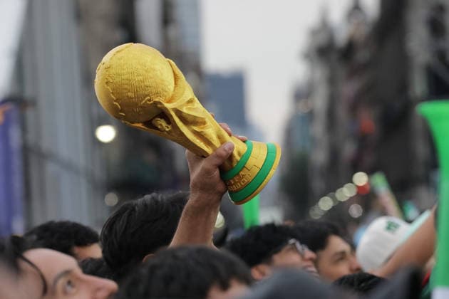Mexicans Support Mexico national team, Nationalteam at FIFA Fan Fest A person lists a replica of FIFA World Cup, WM, Weltmeisterschaft, Fussball trophy at the Mexico FIFA Fan Fest in the main square Zocalo to support the Mexico national team in their FIFA World Cup first-round match against Korea. on June 18, 2026 in Mexico City, Mexico. (Photo by Ian Robles Eyepix Group) Copyright: xIanxRobles xEyepixxGroupx EL_09062026_187930JPEG