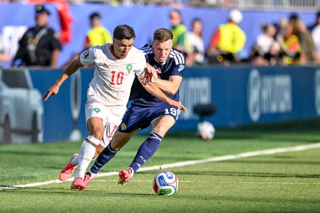 Brahim Diaz of Morocco and Lewis Ferguson of Scotland battle for the ball during the 2026 FIFA World Cup Group C match between Scotland and Morocco at Boston Stadium on June 19, 2026, in Boston, United States. Photo by Harry Langer, DeFodi Images,detected_source_language