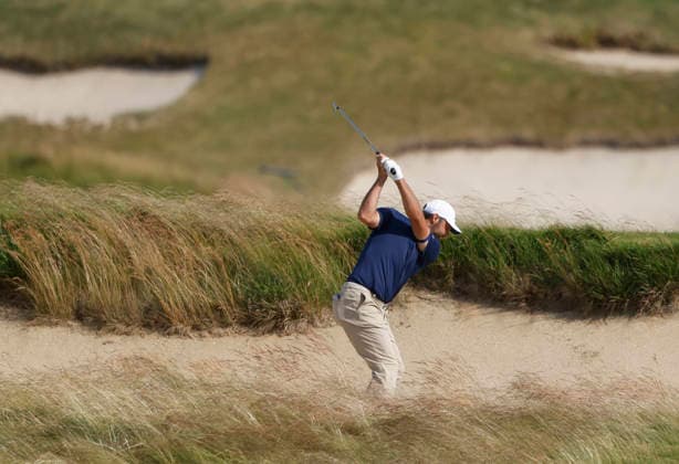 Scottie Scheffler hits out of a fairway bunker on the 18th hole in the second round of the 126th U.S. Open Golf Championship at Shinnecock Hills Golf Club in Southampton, NY on Friday, June 19, 2026.  NYC202606191024 JOHNxANGELILLO