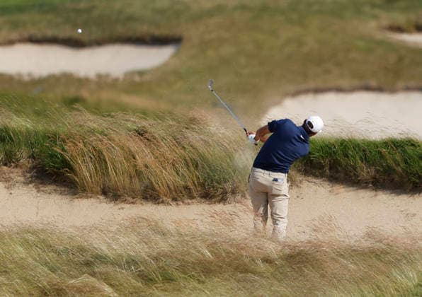 Scottie Scheffler hits out of a fairway bunker on the 18th hole in the second round of the 126th U.S. Open Golf Championship at Shinnecock Hills Golf Club in Southampton, NY on Friday, June 19, 2026.  NYC202606191025 JOHNxANGELILLO