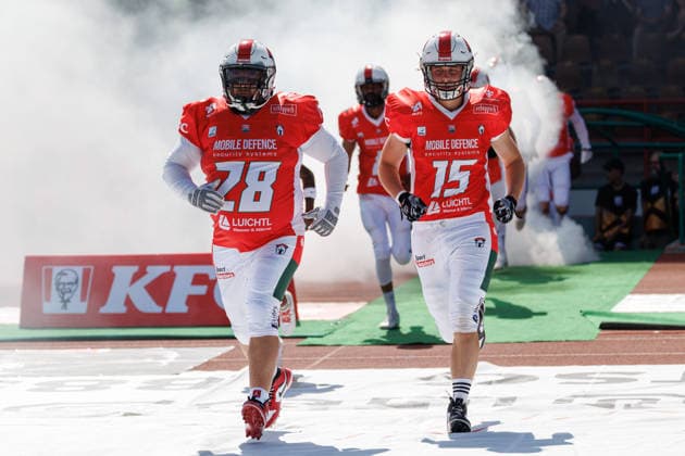 Stefan Fischer, 28, of the Augsburg Centurions, and Laurin Götzelmann, 15, of the Augsburg Centurions, during the game between the Augsburg Centurions and the Gießen Golden Dragons, American football, men’s, GFL2, 2026, Matchday 7 on June 20, 2026, in Augsburg, Rosenaustadion, Bavaria, Germany,detected_source_language