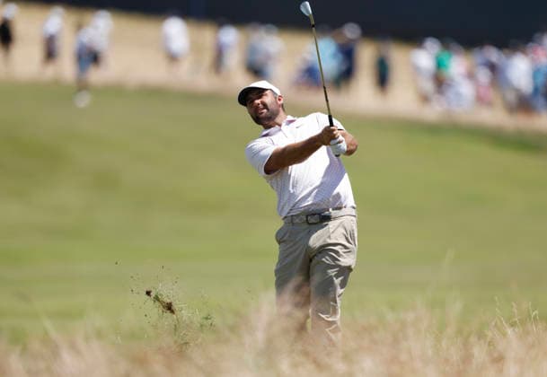 Scottie Scheffler hits an approach shot to the first hole in the third round of the 126th U.S. Open Golf Championship at Shinnecock Hills Golf Club in Southampton, NY on Saturday, June 20, 2026.  NYC202606202004 JOHNxANGELILLO