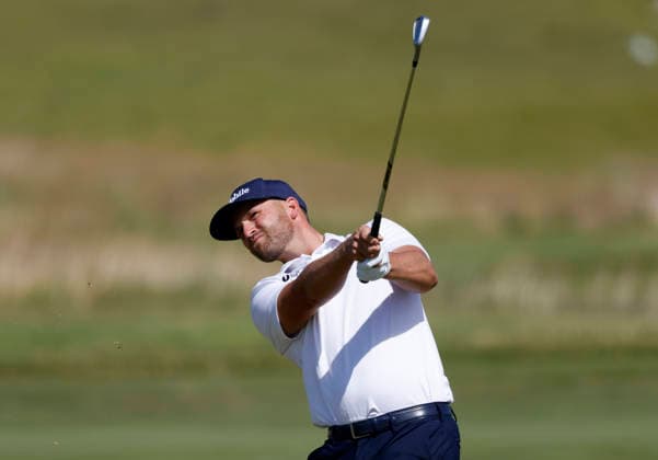 Wyndham Clark hits an approach shot to the first hole in the third round of the 126th U.S. Open Golf Championship at Shinnecock Hills Golf Club in Southampton, NY on Saturday, June 20, 2026.  NYC202606202016 JOHNxANGELILLO