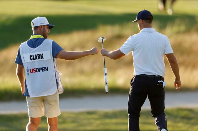 Wyndham Clark celebrates with his caddie after an eagle on the 16th hole during the third round of the 126th U.S. Open Golf Championship at Shinnecock Hills Golf Club in Southampton, NY, on Saturday, June 20, 2026.  NYC20260620834 JOHNxANGELILLO