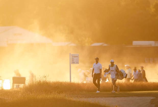 Wyndham Clark and his caddie walk to the 18th tee as the sun sets during the third round of the 126th U.S. Open Golf Championship at Shinnecock Hills Golf Club in Southampton, NY, on Saturday, June 20, 2026.  NYC20260620836 JOHNxANGELILLO