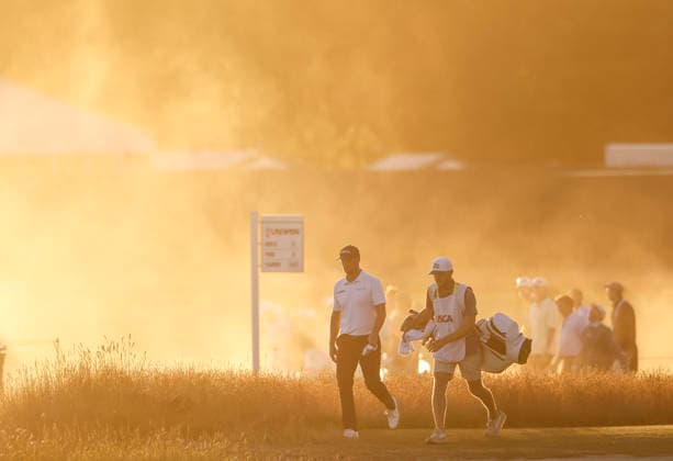 Wyndham Clark and his caddie walk to the 18th tee as the sun sets during the third round of the 126th U.S. Open Golf Championship at Shinnecock Hills Golf Club in Southampton, NY, on Saturday, June 20, 2026.  NYC20260620837 JOHNxANGELILLO