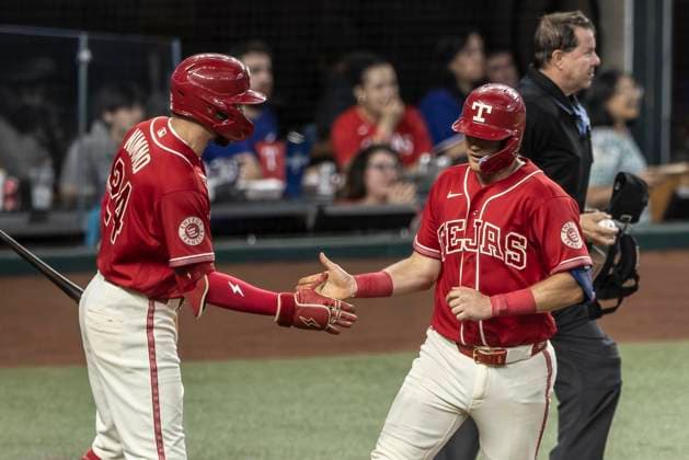 June 20, 2026, Arlington, Texas, USA: Texas Rangers right fielder BRANDON NIMMO (24) congratulates Texas Rangers third baseman JOSH JUNG (6) after scoring during a MLB, Baseball Herren, USA game between the San Diego Padres and Texas Rangers at Globe Life Field. San Diego wins in extra innings 6-4. Arlington USA - ZUMAf180 20260620_zsp_f180_003 Copyright: xMarkxFannx