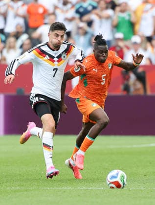 (260621) -- TORONTO, June 21, 2026 -- Kai Havertz (L) of Germany vies with Wilfried Singo of Cote d Ivoire during the group E match between Germany and Cote d Ivoire at the 2026 FIFA World Cup, WM, Weltmeisterschaft, Fussball at Toronto Stadium in Toronto, Canada, on June 20, 2026. (Photo by Xinhua) (SP)CANADA-TORONTO-FOOTBALL-FIFA WORLD CUP-GROUP E-GER VS CIV ZouxZheng 