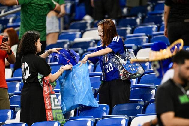 Football, 2026 FIFA World Cup, Tunisia v Japan, Japanese fans pick up rubbish in the stands