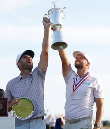 Wyndham Clark celebrates with his caddie David Pelekoudas after winning the 126th U.S. Open Golf Championship at Shinnecock Hills Golf Club in Southampton, NY, on Sunday, June 21, 2026. Clark won with a four-under-par score of 276.  NYC20260621950 COREYxSIPKIN