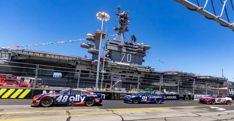 SAN DIEGO, CA - JUNE 21: Alex Bowman of the 48 Hendrick Motorsports Ally Chevrolet, Kevin Magnussen of the 91 Trackhouse Racing Qualcomm Chevrolet, and Cole Custer of the 41 Haas Factory Team Texas A&M Chevrolet, among the field passing turn 2 and the USS Carl Vinson (CVN70) during the Anduril 250 NASCAR, Motorsport, USA Cup Series Race, Sunday, June 21, 2026, at Naval Base Coronado in San Diego, California. (Photo by Tony Ding Icon Sportswire) AUTO: JUN 21 NASCAR Cup Series Anduril 250 Race the Base EDITORIAL USE ONLY Icon46520260621019250