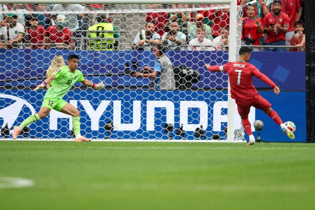 HOUSTON, TX - JUNE 23: Abduvohid Nematov 12 of Uzbekistan watches the ball as Cristiano Ronaldo 7 of Portugal cannot get a toe on it during the FIFA World Cup, WM, Weltmeisterschaft, Fussball 2026 Group K match between Portugal and Uzbekistan on June 23, 2026, at Houston Stadium in Houston, Texas. (Photo by David Buono Icon Sportswire) SOCCER: JUN 23 FIFA World Cup 26 Group K - Portugal vs Uzbekistan EDITORIAL USE ONLY Icon260623012