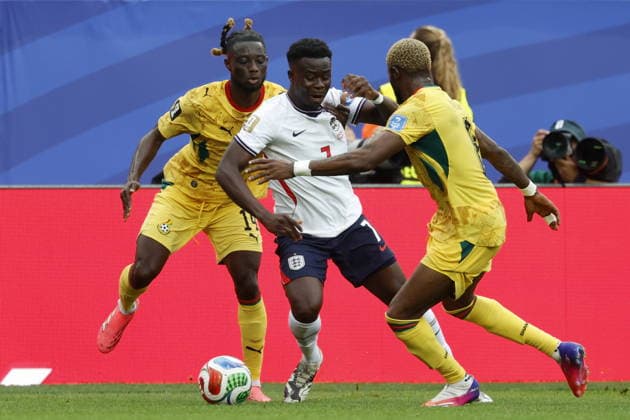 FIFA World Cup, WM, Weltmeisterschaft, Fussball 2026 - Group L - England vs Ghana Gideon Mensah (L) and Kwasi Sibo (R) of Ghana in action against Bukayo Saka of England (C) during the FIFA World Cup 2026 group stage match England against Ghana, in Boston, Massachusetts, USA, 23 June 2026. Foxborough United States  Copyright: xGREGxM.xCOOPERx