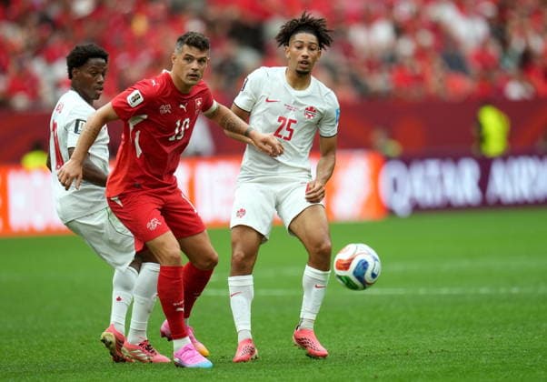 FIFA World Cup, WM, Weltmeisterschaft, Fussball 2026 - Group B - Switzerland vs Canada Nathan Saliba of Canada (R) and Granit Xhaka of Switzerland in action during the FIFA World Cup 2026 group stage match Switzerland against Canada, in Vancouver, Canada, 24 June 2026. VANCOUVER Canada  Copyright: xBOBxFRIDx