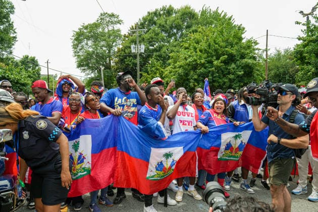 June 24, 2026, Atlanta, Georgia, United States of America: Haiti fans holding up the Haitian flag poses for the cameras before the Haiti fan march before the Morocco vs Haiti First Stage Group C match in ATLANTA, Georgia. Atlanta United States of America - ZUMAg276 20260624_zsp_g276_002 Copyright: xMalachixGabrielx