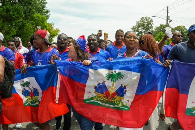 June 24, 2026, Atlanta, Georgia, United States of America: Haiti fans holding up the Haitian flag poses for the cameras during the Haiti fan march before the Morocco vs Haiti First Stage Group C match in ATLANTA, Georgia. World Cup 2026: Group C: Morocco : Haiti  - ZUMAg276 20260624_zsp_g276_004 Copyright: xMalachixGabrielx