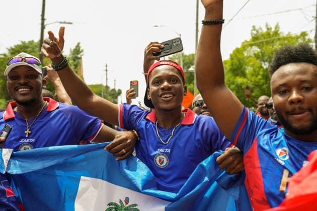 June 24, 2026, Atlanta, Georgia, United States of America: Three Haiti fans holding up the Haitian flag for the cameras during the Haiti fan march before the Morocco vs Haiti First Stage Group C match in ATLANTA, Georgia. World Cup 2026: Group C: Morocco : Haiti  - ZUMAg276 20260624_zsp_g276_019 Copyright: xMalachixGabrielx