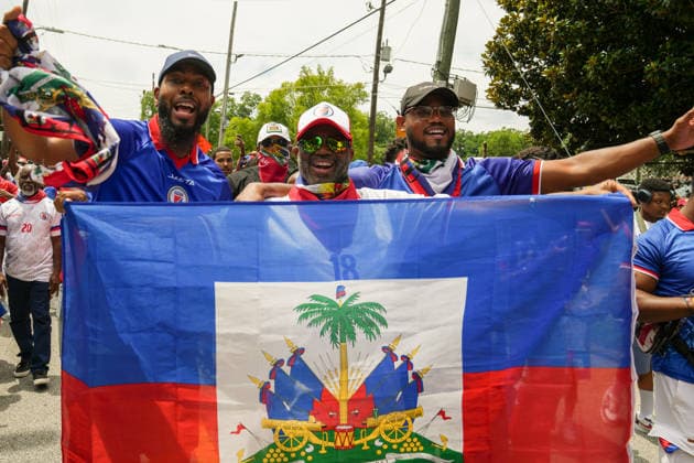 June 24, 2026, Atlanta, Georgia, United States of America: Three Haiti fans holding up the Haitian flag for the cameras during the Haiti fan march before the Morocco vs Haiti First Stage Group C match in ATLANTA, Georgia. World Cup 2026: Group C: Morocco : Haiti  - ZUMAg276 20260624_zsp_g276_022 Copyright: xMalachixGabrielx