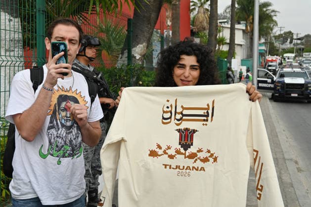 Iranian national team, Nationalteam FIFA World Cup, WM, Weltmeisterschaft, Fussball 2026 leave Mexico camp to Seattle match to face Egypt TIJUANA, MEXICO - JUNE 24: Yalda (right), a Tijuana-based Iranian citizen, who works as a painter, shows off t-shirts she produced for the Iranian National team before their leave from the Marriott Hotel to the Tijuana International Airport upon the team’s departure for Seattle, Washington, where it will play against Egypt on Friday in Tijuana, Mexico, on Wednesday, June 24, 2026, as part of the 2026 World Cup football tournament. (Carlos A. Moreno for Anadolu Images) Carlos Moreno Anadolu Tijuana Mexico. Editorial use only. Please get in touch for any other usage.  Copyright: x2026xAnadoluxCarlosxMorenox