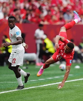 June 24, 2026, Vancouver, Bc, CANADA: Switzerland s Luca Jaquez (25) is upended by Canada s Richie Laryea (22) during the first half of a World Cup Group B soccer match, in Vancouver, on Wednesday, June 24, 2026. Canada News - June 24, 2026  - ZUMAc35_ 20260624_zaf_c35_108 Copyright: xDarrylxDyckx